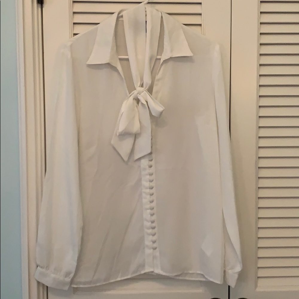 White long sleeve blouse with buttons and bow